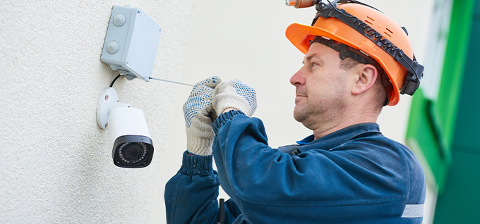 Technician repairing security camera