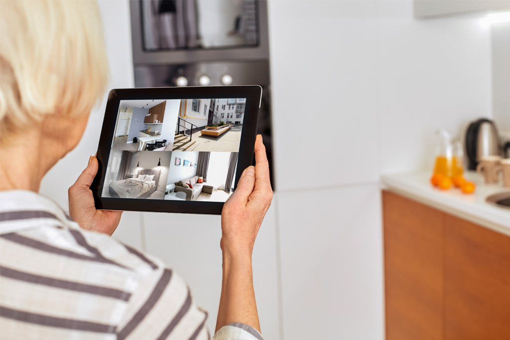 Woman checking residential security cameras on her tablet